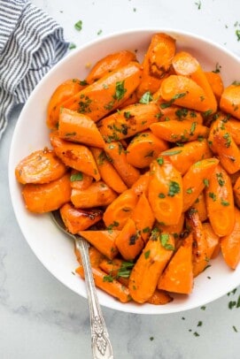 a white plate with glazed and roasted carrots