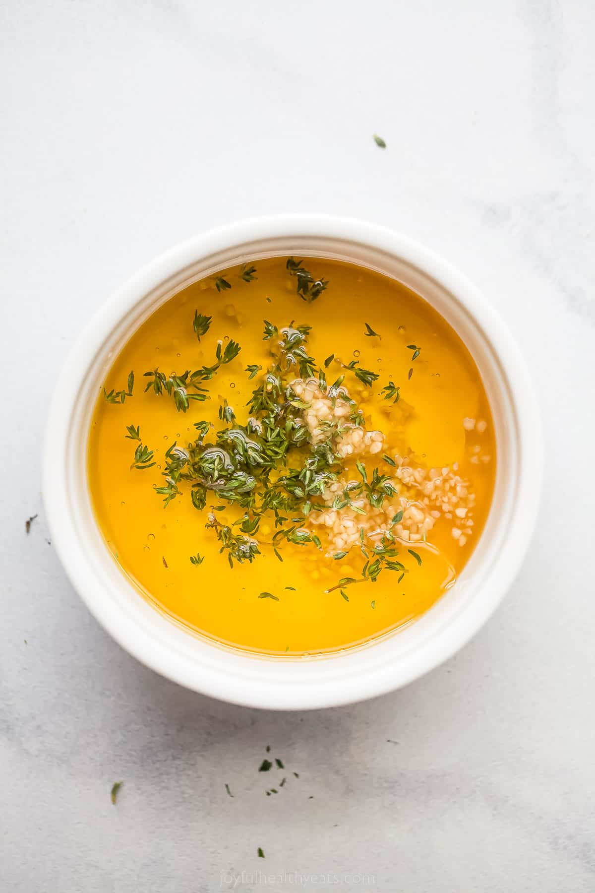 a small bowl with honey, olive oil, and spices