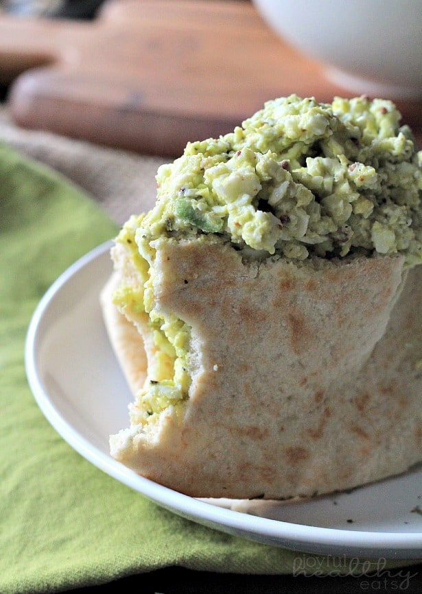 An Avocado Egg Salad Sandwich with Two Bites Taken Out