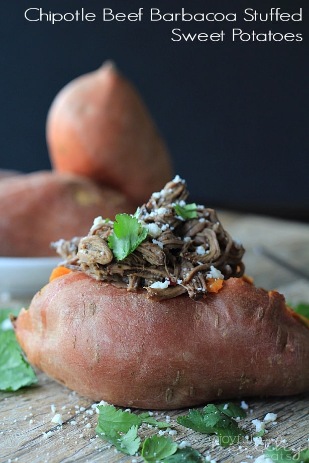 Chipotle Beef Barbacoa Stuffed Sweet Potato on a wooden board