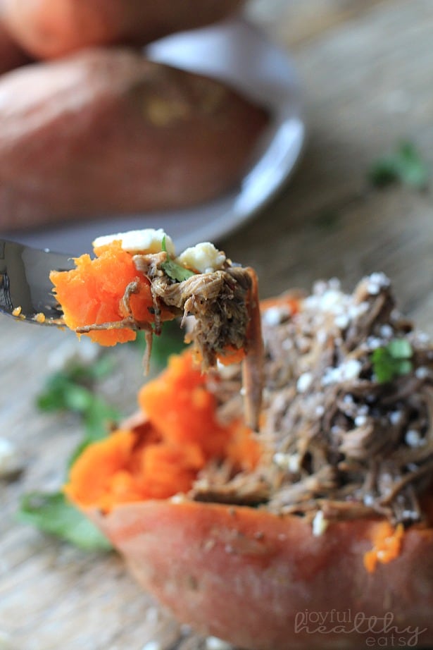 A bite of Chipotle Beef Barbacoa Stuffed Sweet Potato on a fork