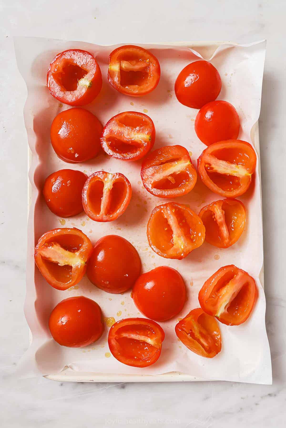 Placing the tomatoes on the baking tray. 