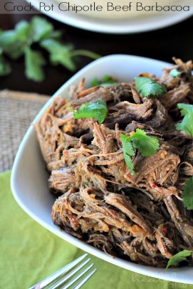 A bowl full of Crock Pot beef barbacoa on top of a green napkin