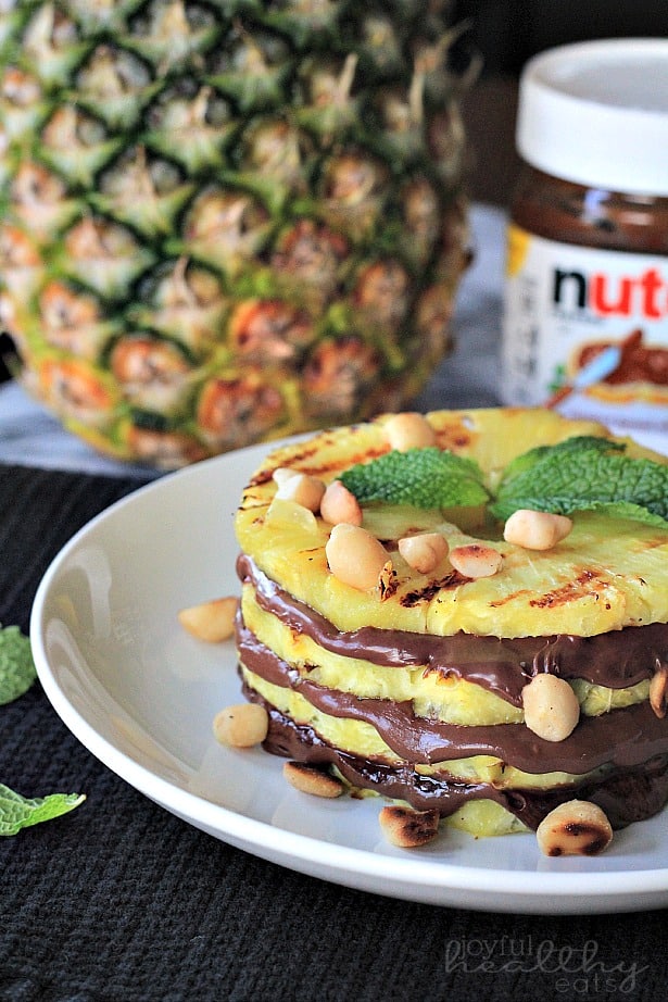 Grilled Pineapple layered with Nutella & Macadamia Nuts on a plate