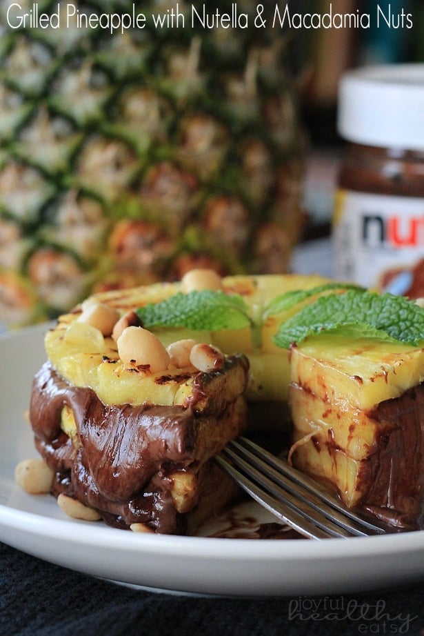 Grilled Pineapple layered with Nutella & Macadamia Nuts on a plate with a wedge missing