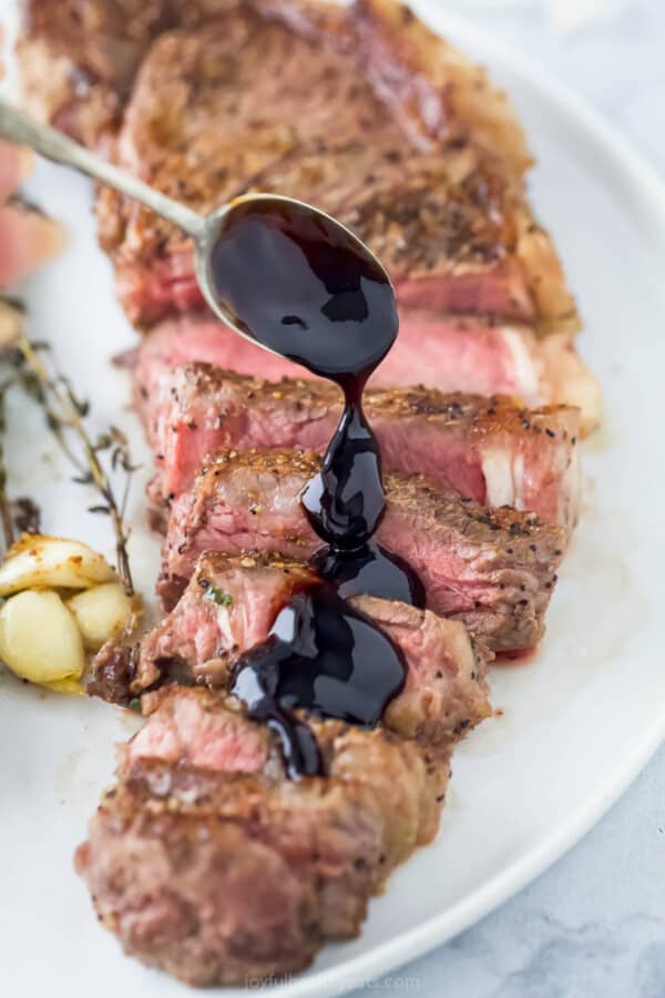 Sliced steak with a drizzle of balsamic reduction.