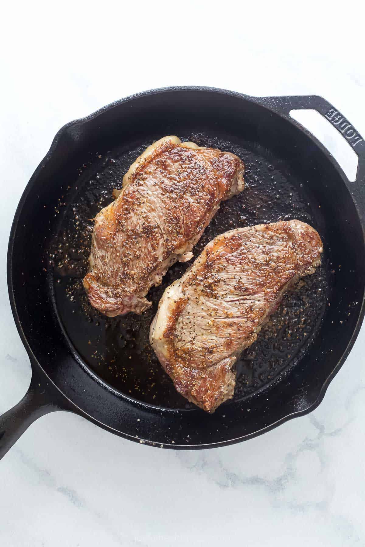 Seared steak on the skillet. 