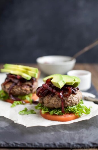 Who says burgers can't be healthy!? Paleo Burgers served on a slice of tomato topped with Caramelized Balsamic Onions that will make you swoon and of course Avocado! A quick 30 minute meal you're family will want on repeat! | joyfulhealthyeats.com #glutenfree