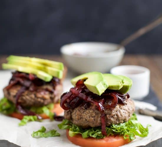 Who says burgers can't be healthy!? Paleo Burgers served on a slice of tomato topped with Caramelized Balsamic Onions that will make you swoon and of course Avocado! A quick 30 minute meal you're family will want on repeat! | joyfulhealthyeats.com #glutenfree