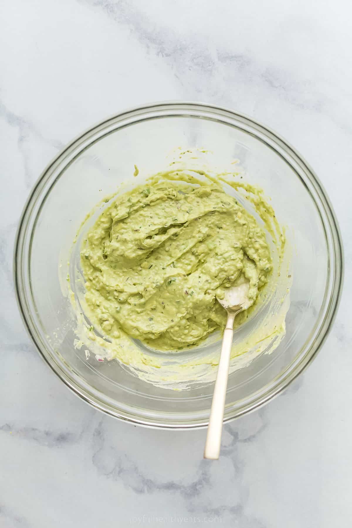 pureed avocado in a large glass bowl