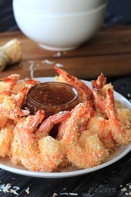 Coconut shrimp on a plate with chili dipping sauce
