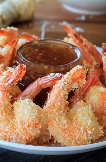 A Plate of Coconut Shrimp Surrounding a Jar of Thai Chili Ginger Sauce