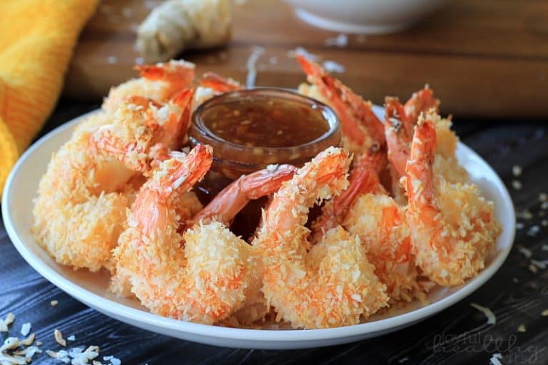 A Plate of Coconut Shrimp Surrounding a Jar of Thai Chili Ginger Sauce
