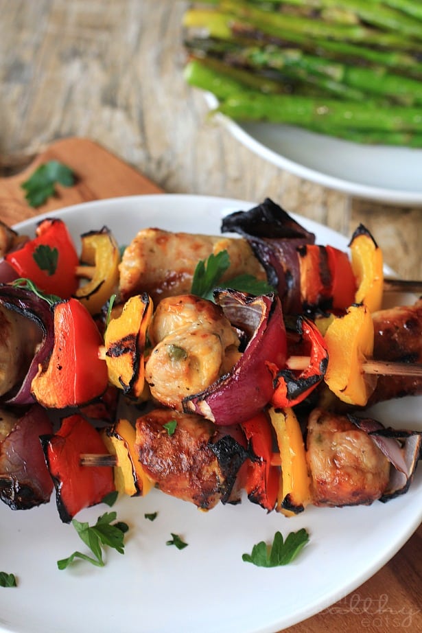 Close-up view of Grilled Chicken, Sausage, Pepper & Onion Kabobs on a plate