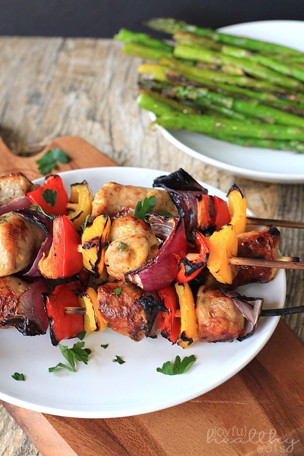 A Stack of Chicken, Sausage, Pepper & Onion Kabobs on a plate