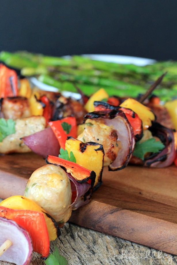 Grilled Chicken, Sausage, Pepper & Onion Kabob on a wooden board