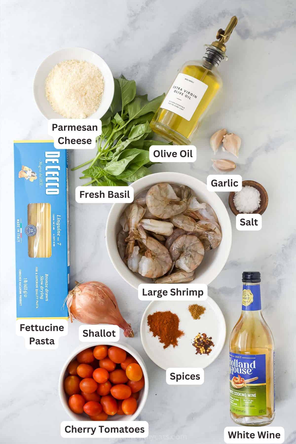 This Spicy Shrimp Pasta is light and flavorful thanks to the addition of blistered cherry tomatoes and fresh basil. A 30-minute dinner! Overhead view of ingredients for spicy shrimp pasta