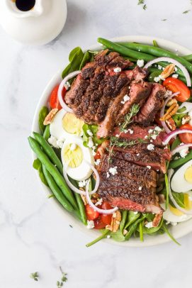 overhead photo of overhead photo of the ultimate ribeye steak salad with hardboiled eggs, tomatoes, onions