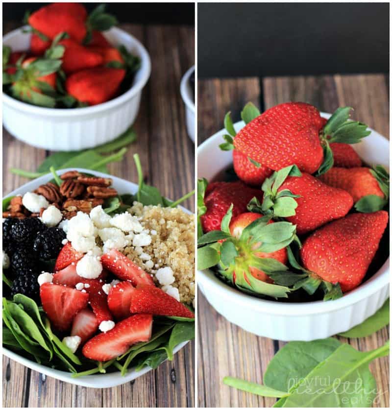 Detox Berry Quinoa Spinach Salad in a bowl with pecans and crumbled goat cheese, and a bowl of fresh strawberries