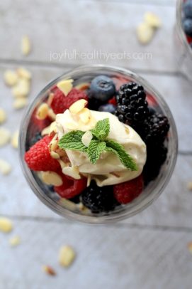 A bowl of fresh berries topped with mascarpone and almonds