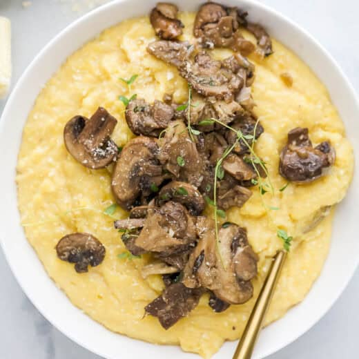 Bowl of mushroom polenta with spoon