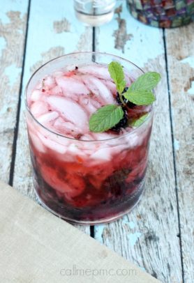 Strawberry blackberry vodka mojito in a glass with ice and fresh mint
