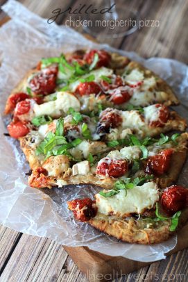 A Grilled Chicken Margherita Pizza on Top of a Piece of Wax Paper