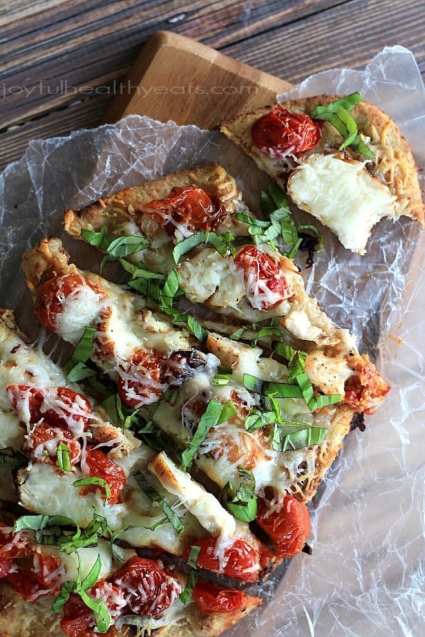 Top view of sliced Grilled Chicken Margherita Pizza on parchment paper