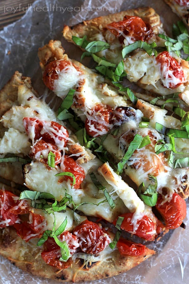 Top view of sliced Grilled Chicken Margherita Pizza on parchment paper