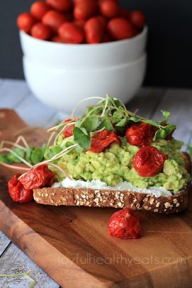 Toast with goat cheese, mashed avocado, roasted cherry tomatoes and microgreens