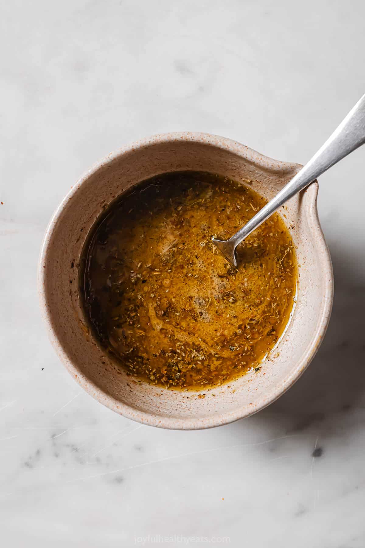 Whisked vinaigrette in a bowl. 