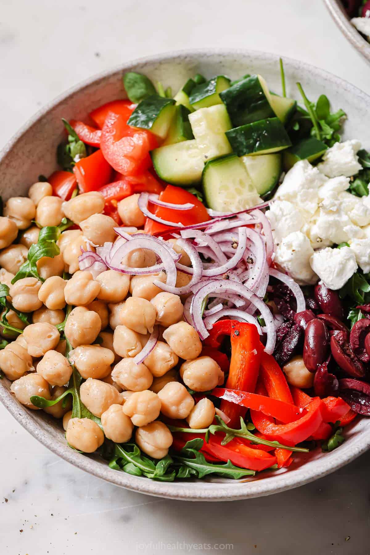 Bowl of Mediterranean salad with ،memade Greek vinaigrette. 