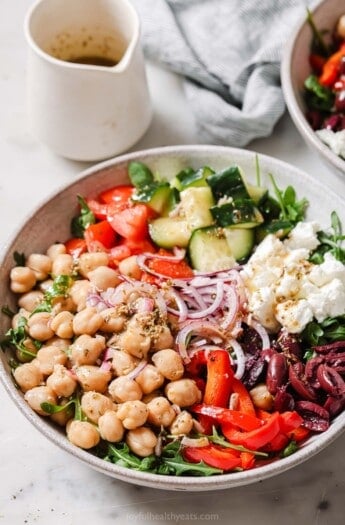 Mediterranean salad full of crunchy veggies with Greek vinaigrette in a bowl.