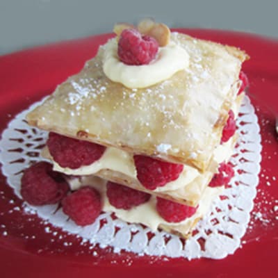 Honey Almond Fillo tart with layers of puffy fillo, custard and fresh raspberries