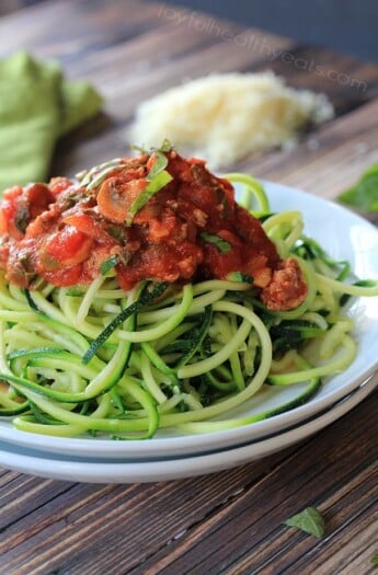 A plate full of Gluten Free & Paleo Zucchini Noodles with Meat Mushroom Tomato Sauce | www.joyfulhealthyeats.com