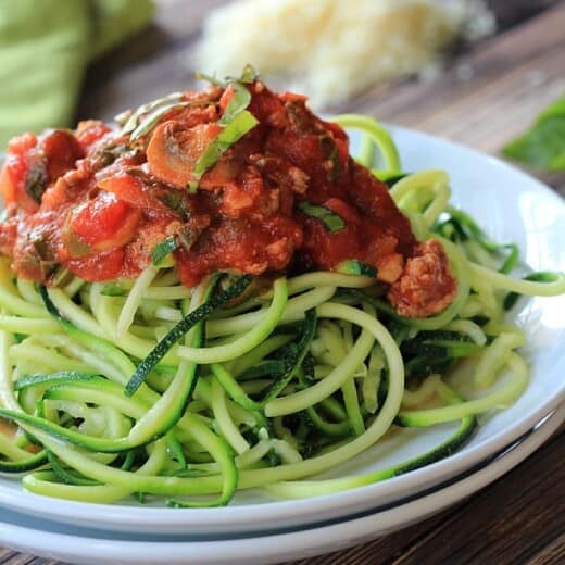 A plate full of Gluten Free & Paleo Zucchini Noodles with Meat Mushroom Tomato Sauce | www.joyfulhealthyeats.com