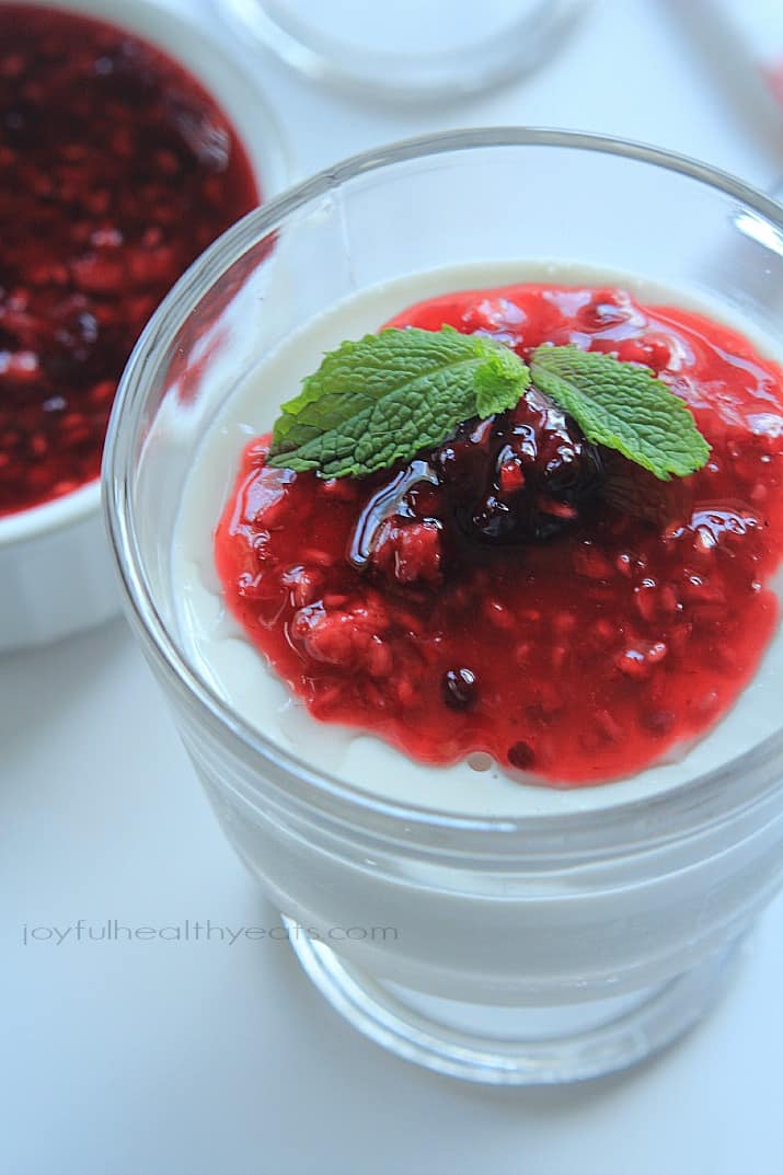 Close-up of Coconut Panna Cotta topped with Raspberry Blackberry Compote in a dessert glass