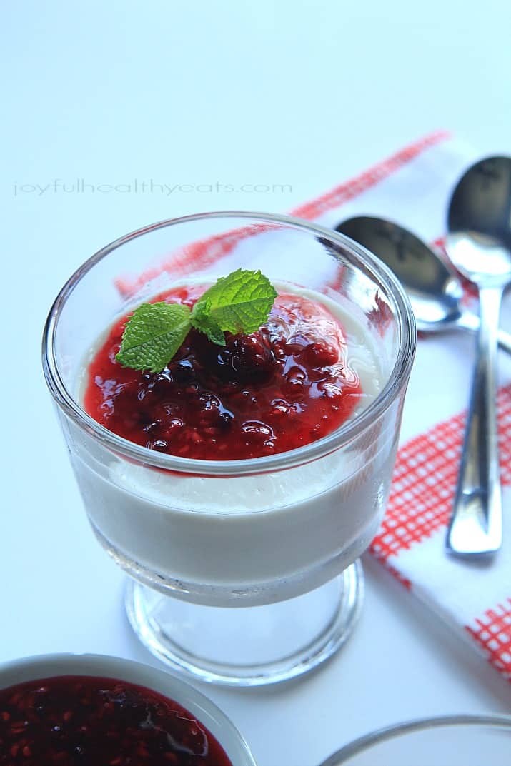 Coconut Panna Cotta topped with Raspberry Blackberry Compote in a dessert glass