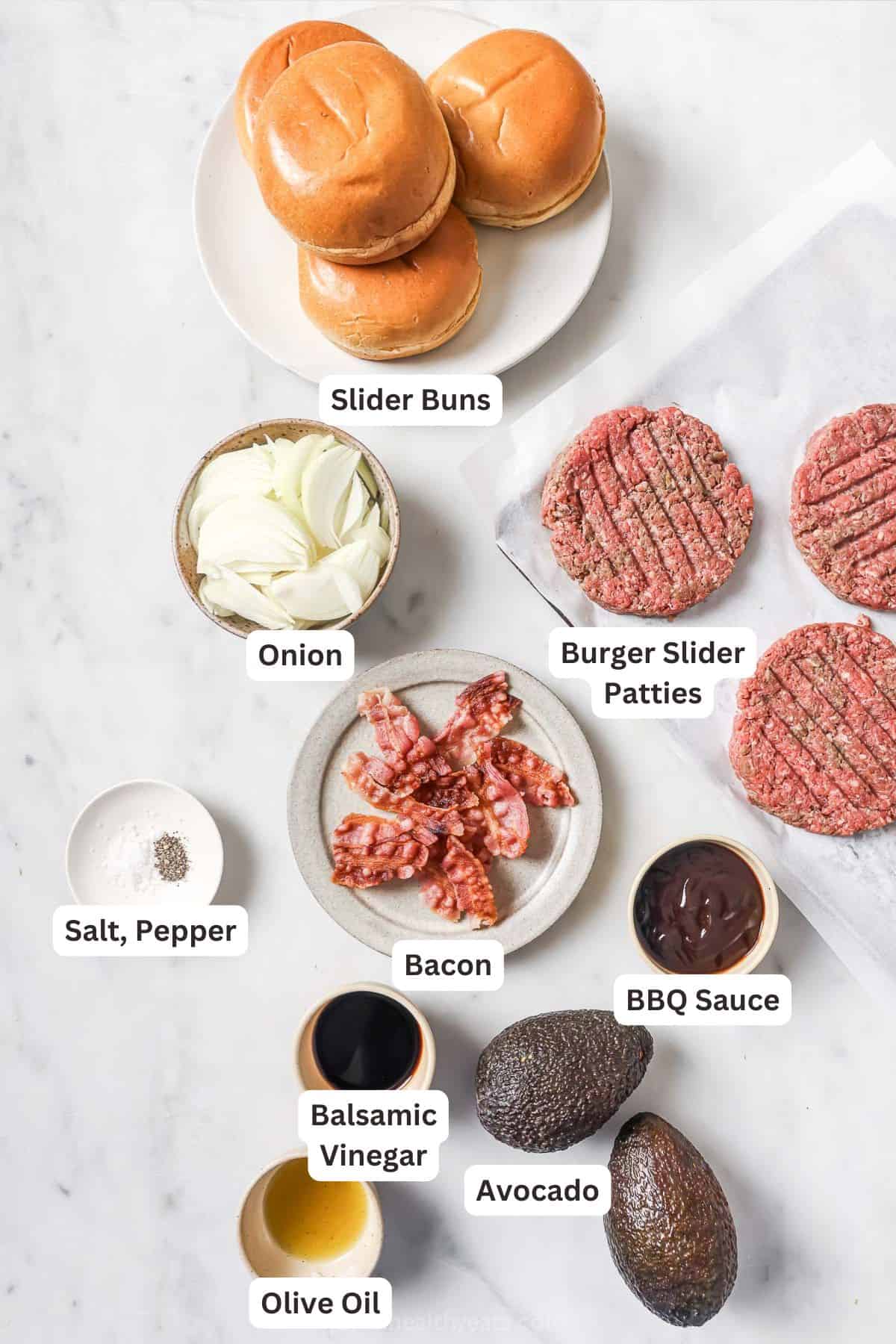 These Cowboy Hamburger Sliders are topped with creamy avocado, balsamic caramelized onions, and crispy bacon. Always a crowd-pleaser! Overhead view of cowboy hamburger slider ingredients