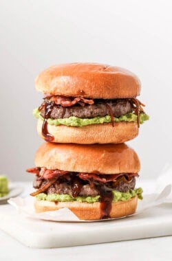 Two cowboy hamburger sliders stacked on board