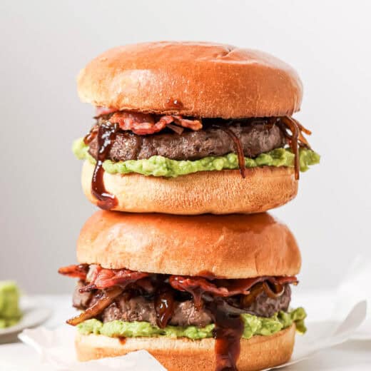 Two cowboy hamburger sliders stacked on board