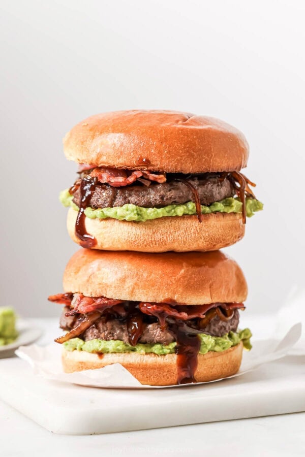 Two cowboy hamburger sliders stacked on board