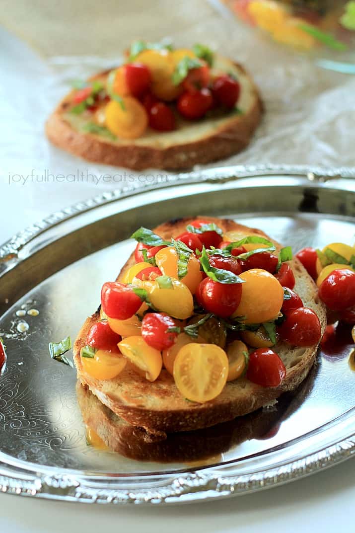 Fresh Tomato Bruschetta on toasted bread on a silver platter