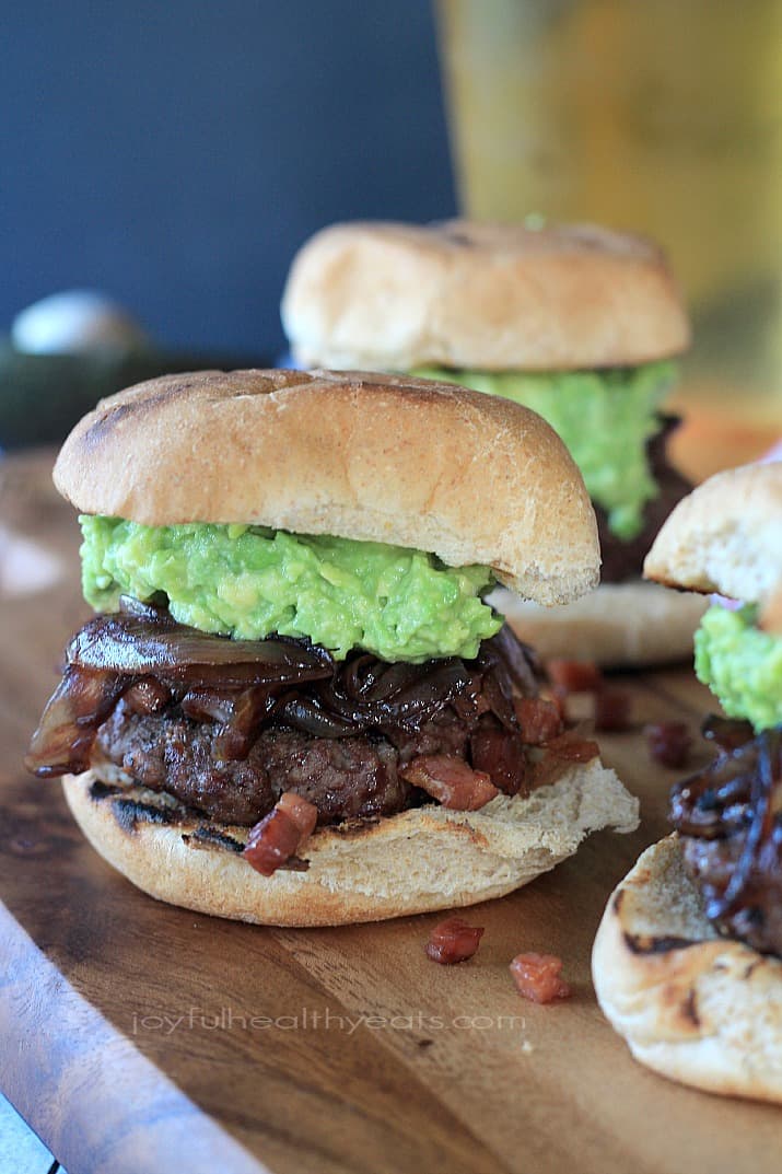 Close-up of Gourmet "Cowboy" Slider burgers on a wooden board