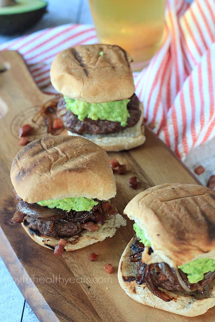 Three Gourmet "Cowboy" Slider burgers on a wooden board
