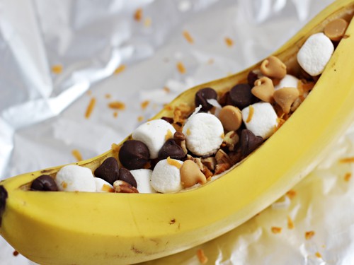 A banana peel sliced open and filled with baking chips and marshmallows