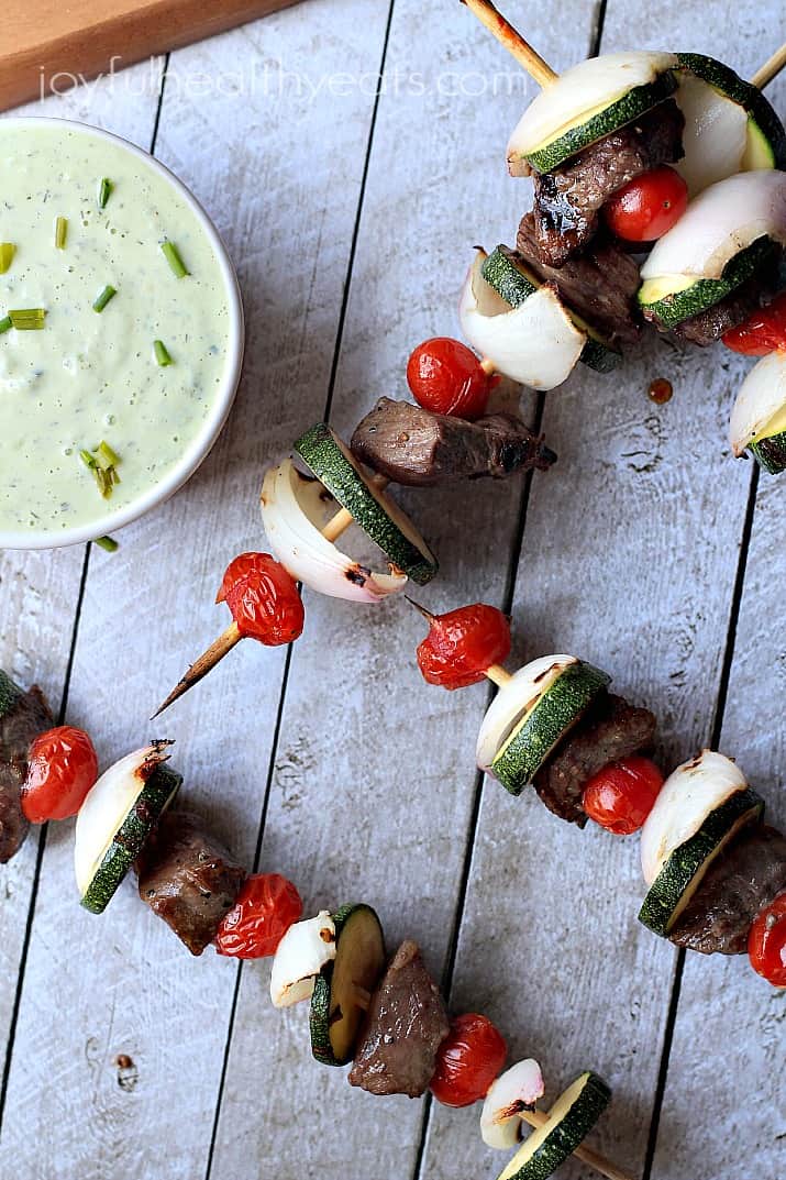 Top view of Grilled Beef Kabobs with a bowl of Avocado Cucumber Tzatziki