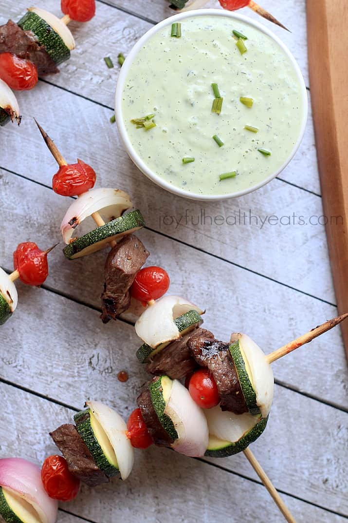 Top view of Grilled Beef Kabobs with a bowl of Avocado Cucumber Tzatziki