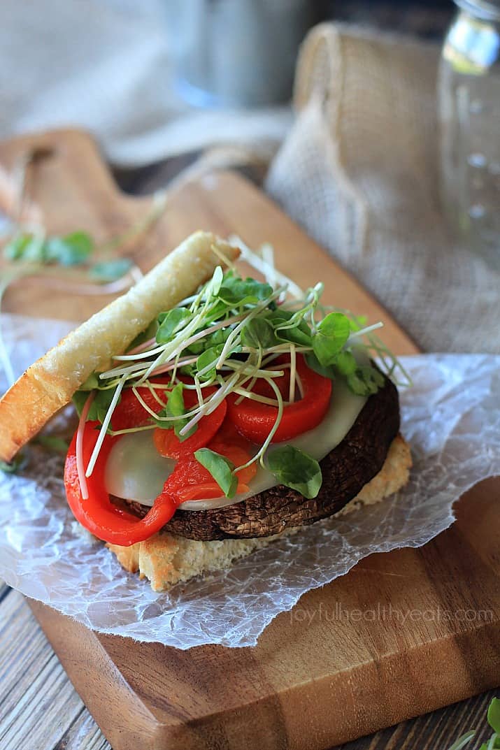 Grilled Portobello Burger with cheese, red pepper and sprouts on a bun