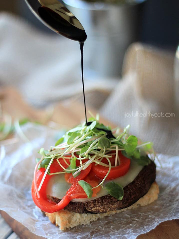 Grilled Portobello Burgers being drizzled with Balsamic Reduction